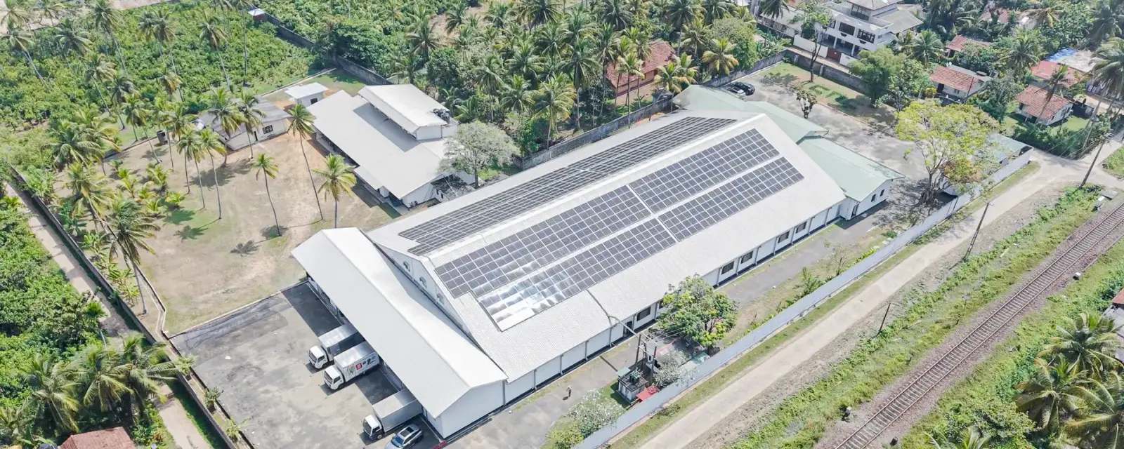 Aerial view of the SDS processing facility in Kosgoda, its roof covered in solar panels